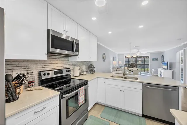 a kitchen with a sink stove and microwave