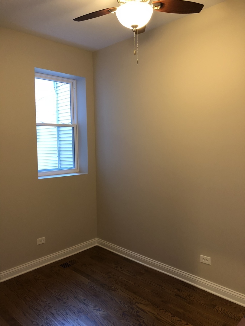 1739 West 18th Street, Unit 1F Chicago, IL 60608 - Photo 5 of 12 a view of a small space with wooden floor and a window