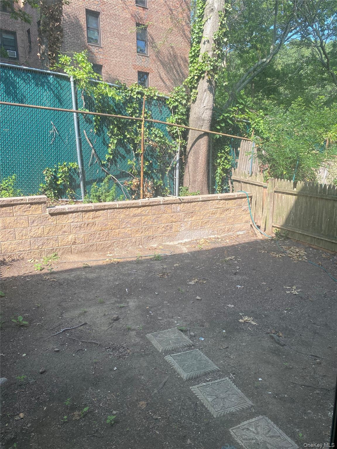 84-24 98th Street, Unit 1 Queens, NY 11421 - Photo 20 of 22 a view of a yard with a street