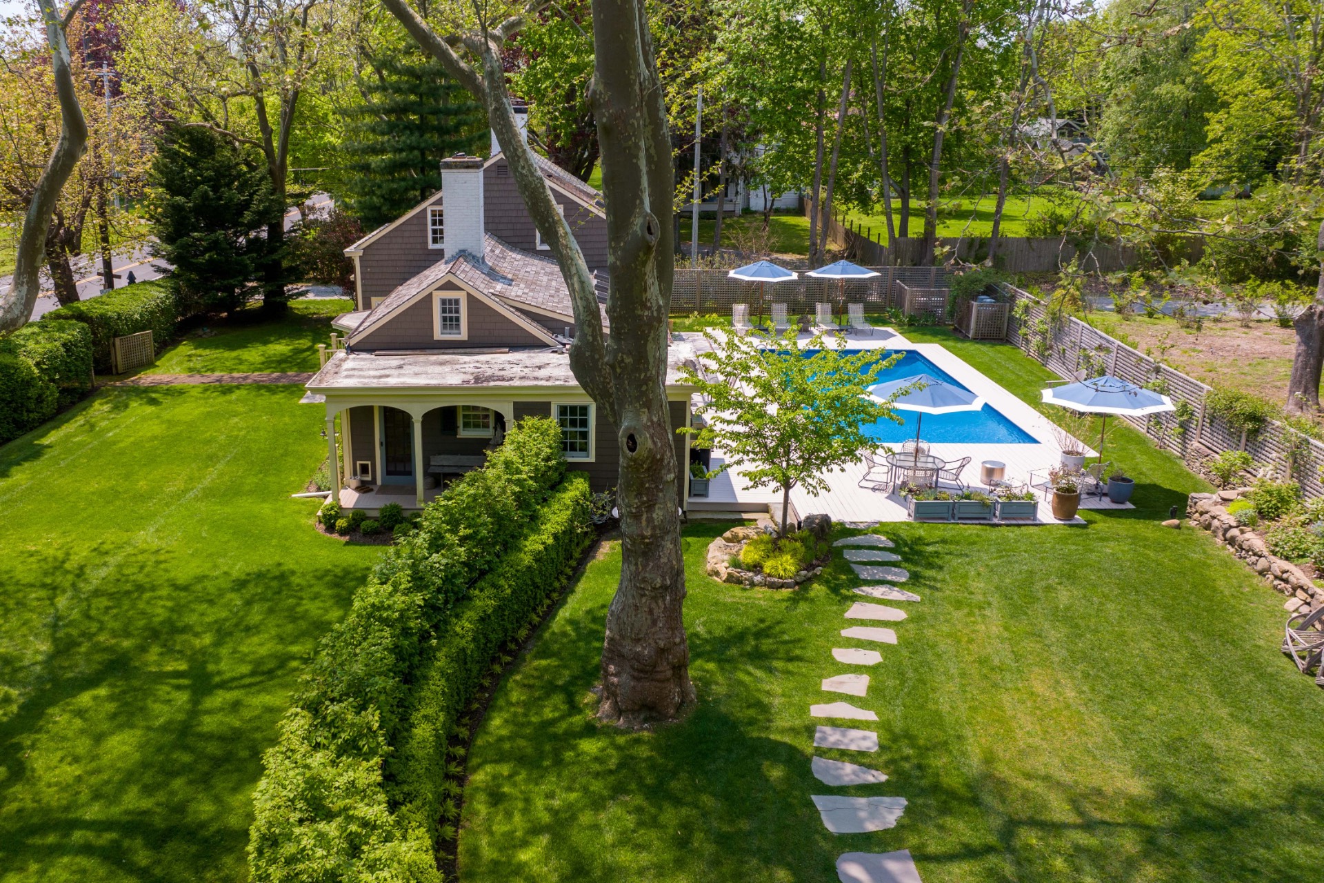 a aerial view of a house with swimming pool garden and patio