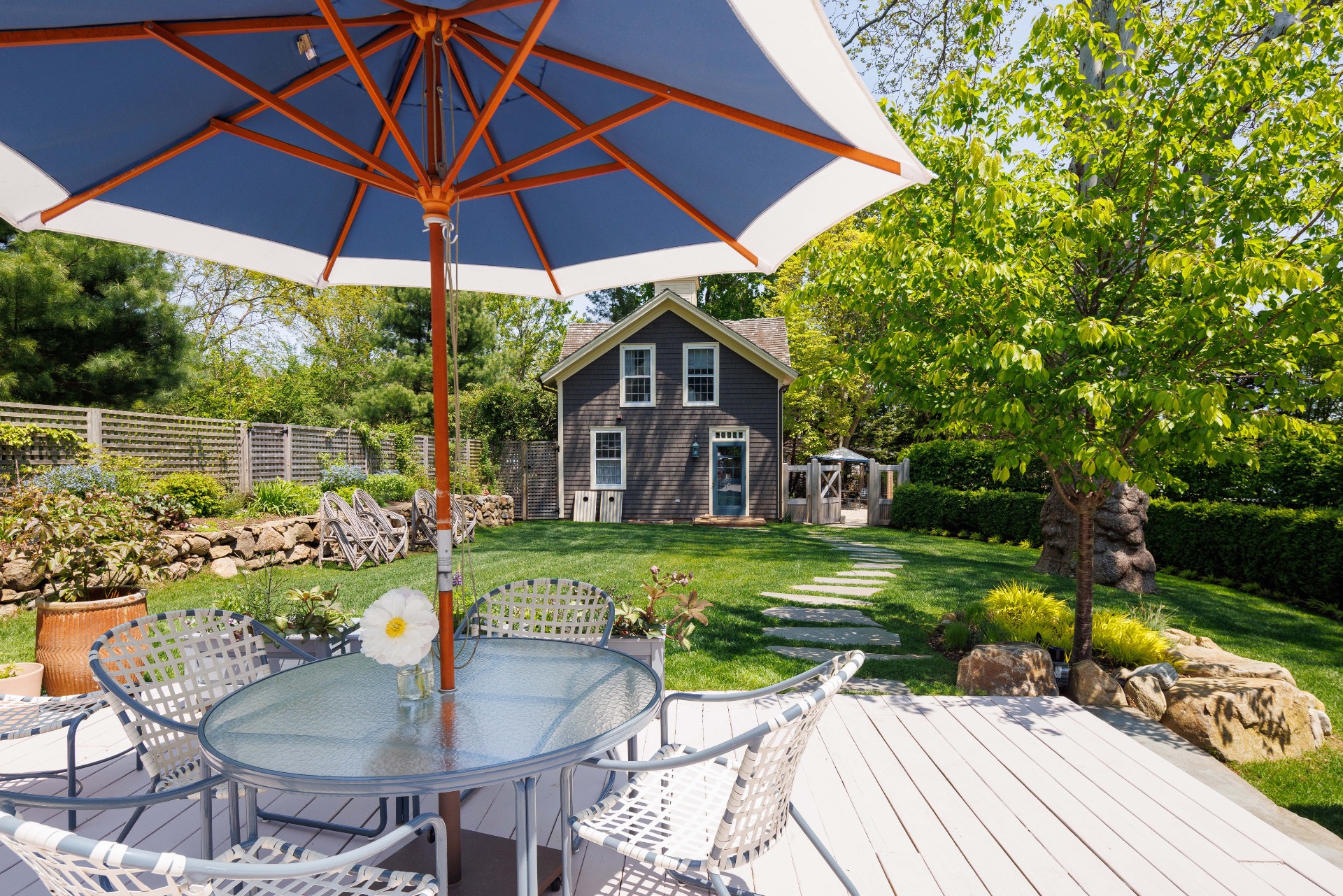25825 Main Road Orient, NY 11957 - Photo 27 of 28 a patio with a table and chairs under an umbrella