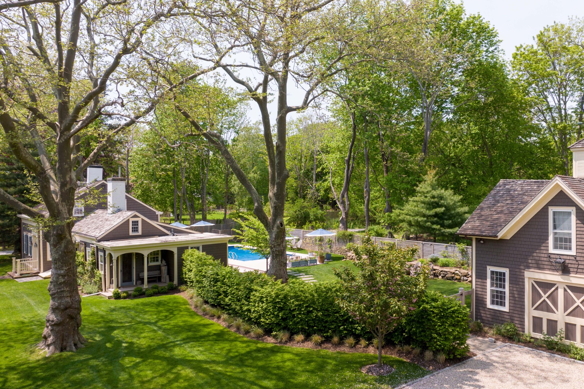 25825 Main Road Orient, NY 11957 - Photo 3 of 28 a front view of a house with a garden and trees