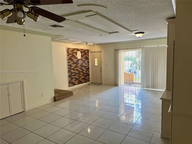 a view of a livingroom with furniture and floor to ceiling window