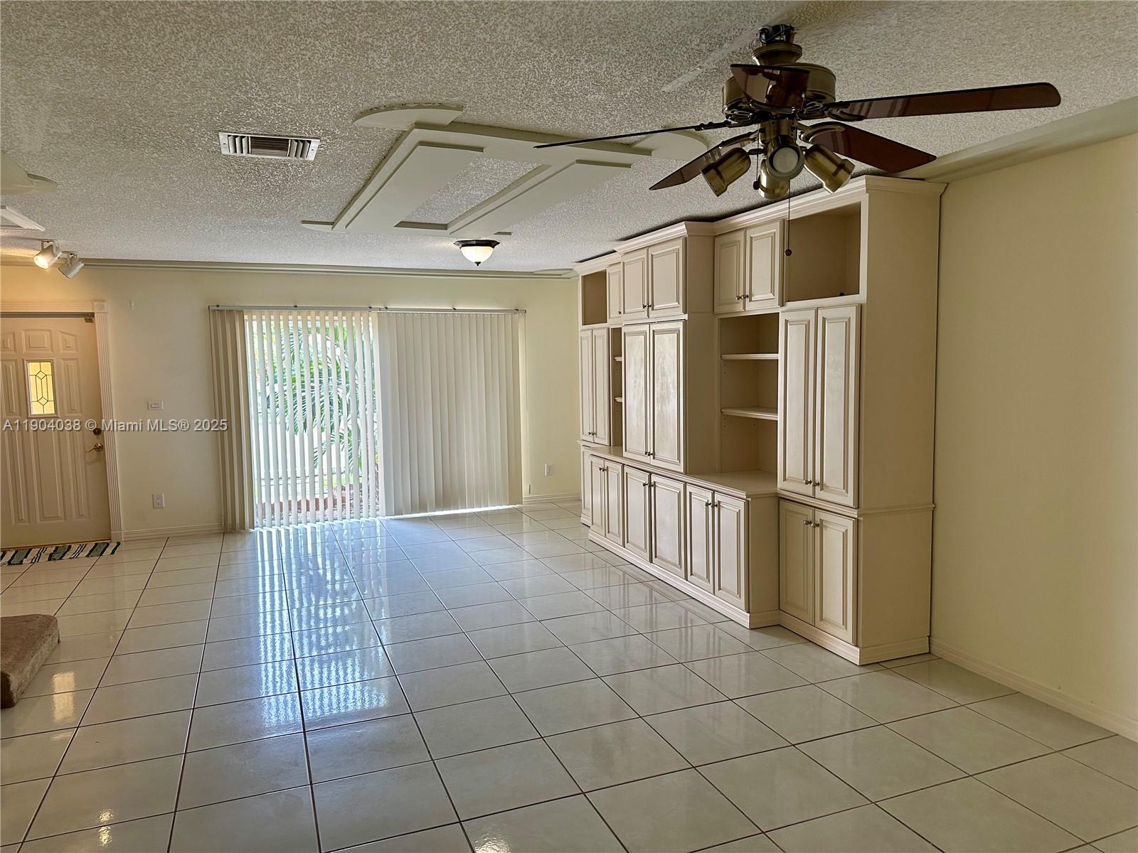 13705 Southwest 84th Street, Unit F Miami, FL 33143 - Photo 5 of 15 a view of a hallway with a glass door