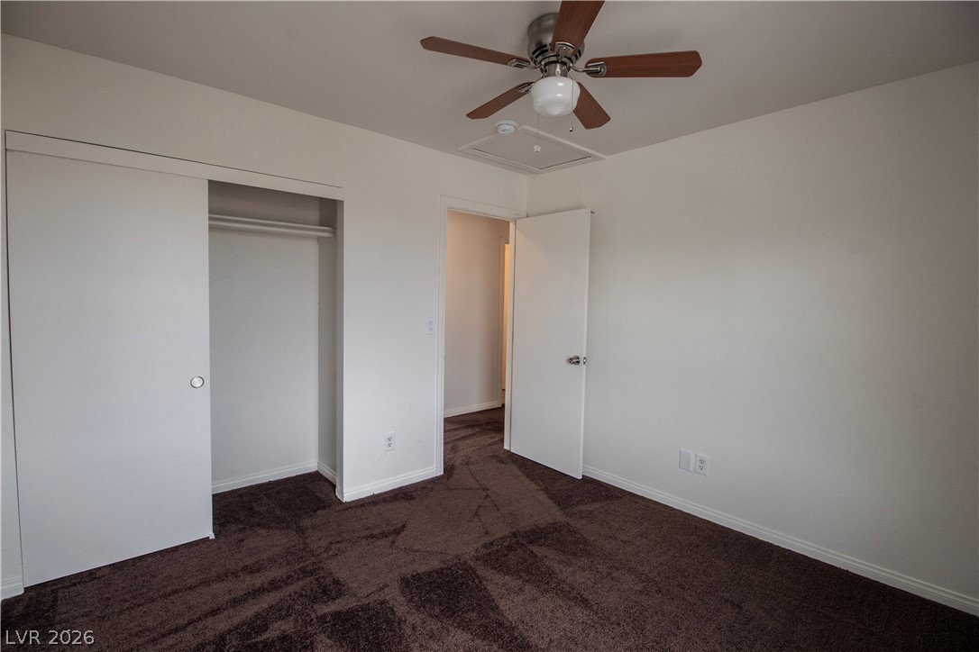119 West Victory Road Henderson, NV 89015 - Photo 20 of 26 Comfortable carpeting and a built-in closet create a cozy retreat in this bedroom.
