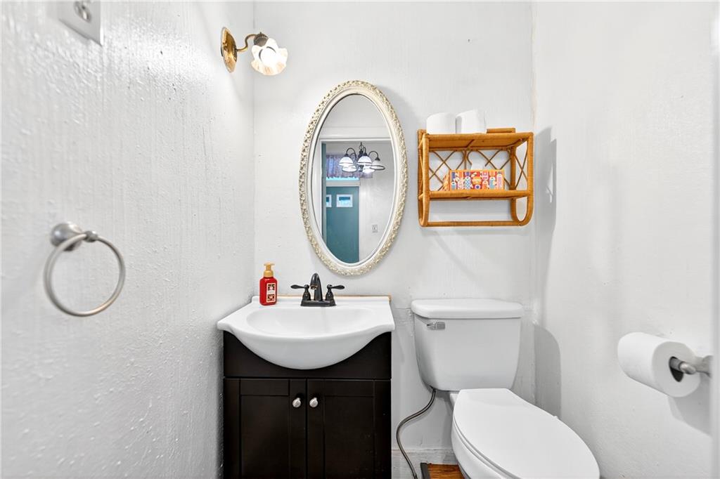 574 Webster Hollow Road Rostraver Township, PA 15012 - Photo 15 of 46 a bathroom with a toilet a sink and a mirror
