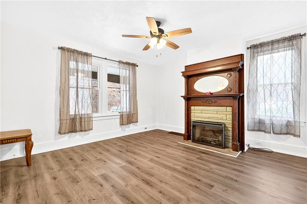 574 Webster Hollow Road Rostraver Township, PA 15012 - Photo 20 of 46 a view of an empty room with wooden floor fireplace and a window