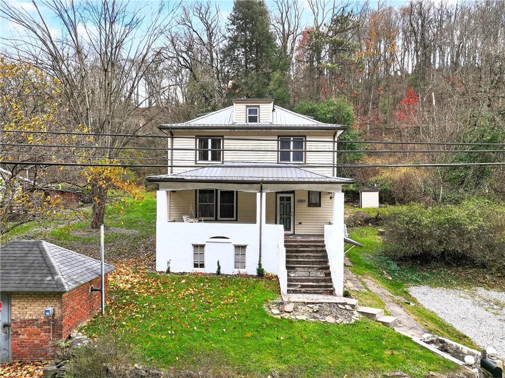 574 Webster Hollow Road Rostraver Township, PA 15012 - Photo 3 of 46 a front view of a house with a garden