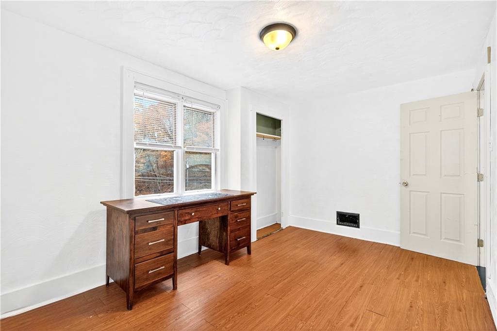 574 Webster Hollow Road Rostraver Township, PA 15012 - Photo 35 of 46 an empty room with wooden floor and windows