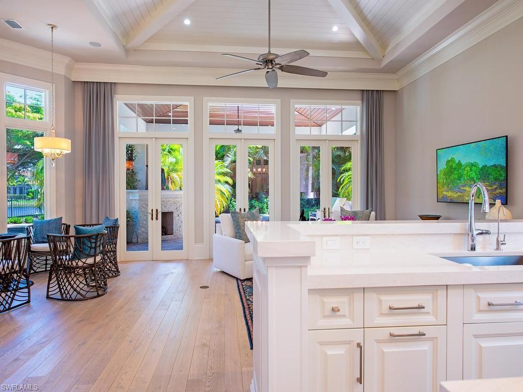 2202 Miramonte Way Naples, FL 34105 - Photo 13 of 23 a view of living room with furniture wooden floor and chandelier