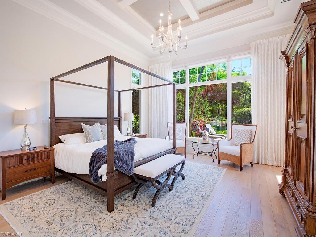 2202 Miramonte Way Naples, FL 34105 - Photo 16 of 23 a spacious bedroom with a bed couch and a window