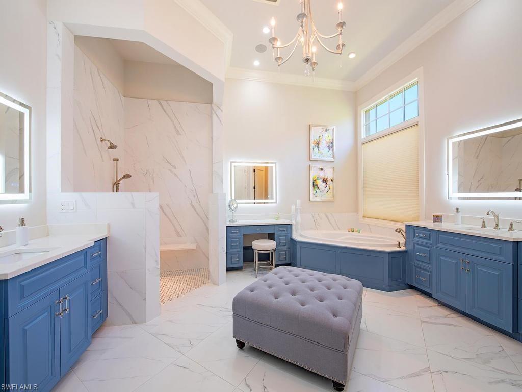 2202 Miramonte Way Naples, FL 34105 - Photo 17 of 23 a spacious en suite bathroom with a tub double sink window and mirror