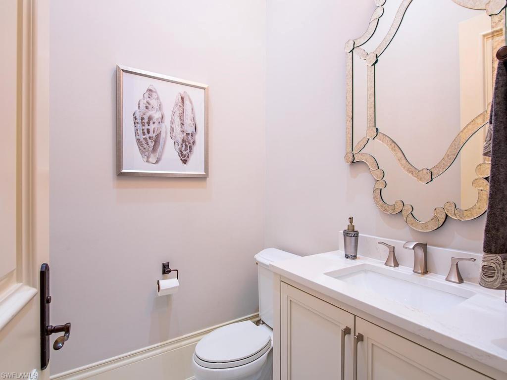 2202 Miramonte Way Naples, FL 34105 - Photo 18 of 23 a bathroom with a toilet sink and mirror