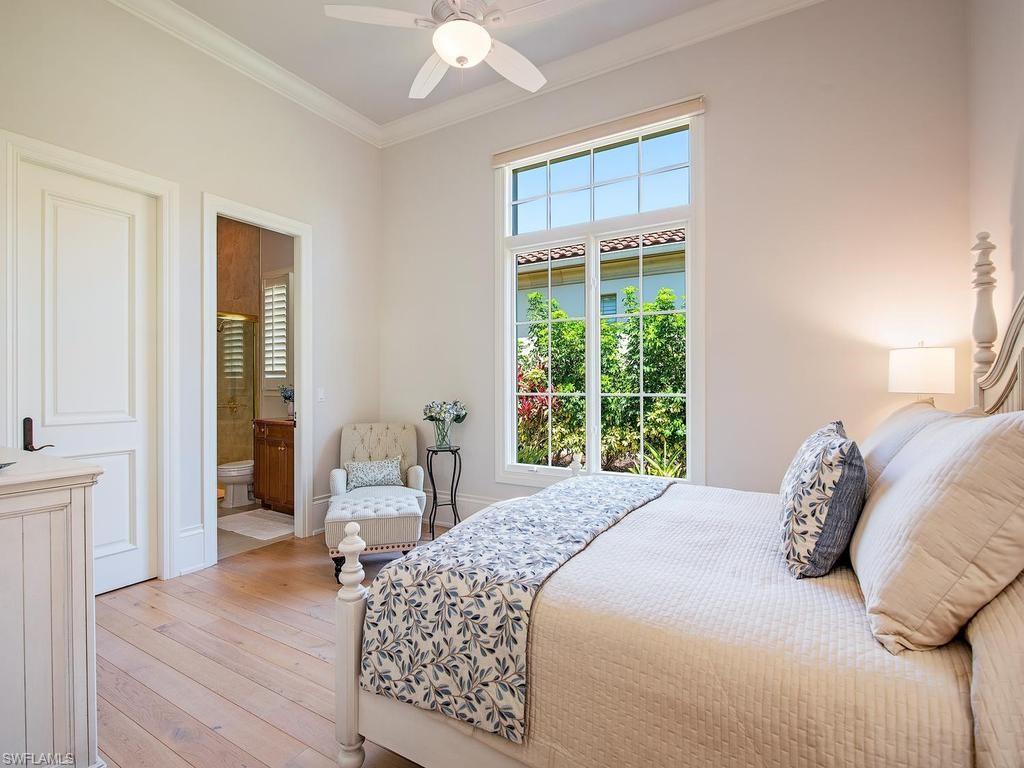 2202 Miramonte Way Naples, FL 34105 - Photo 20 of 23 a bedroom with a bed and wooden floor
