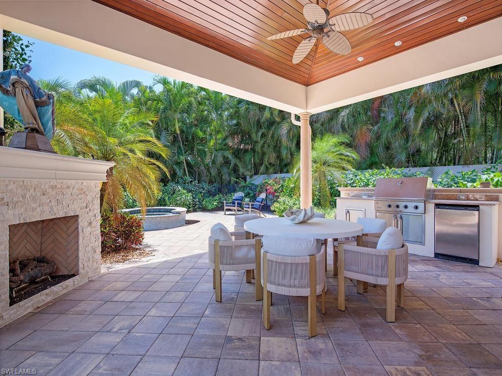 2202 Miramonte Way Naples, FL 34105 - Photo 4 of 23 a view of a patio with a table and chairs