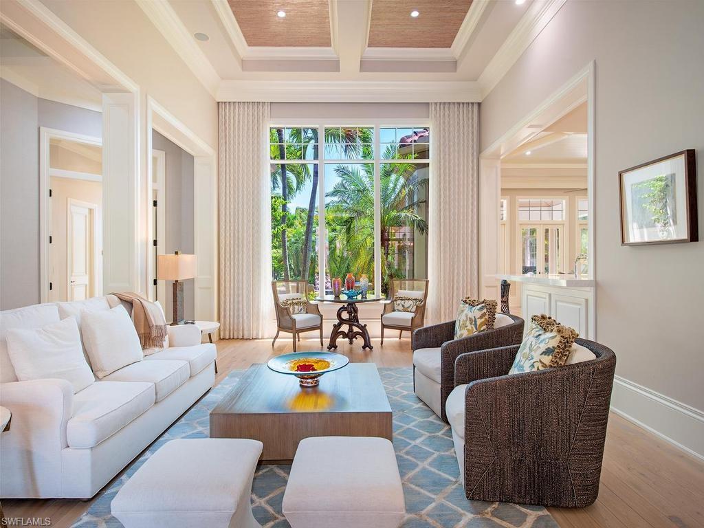 2202 Miramonte Way Naples, FL 34105 - Photo 8 of 23 a living room with furniture and floor to ceiling windows