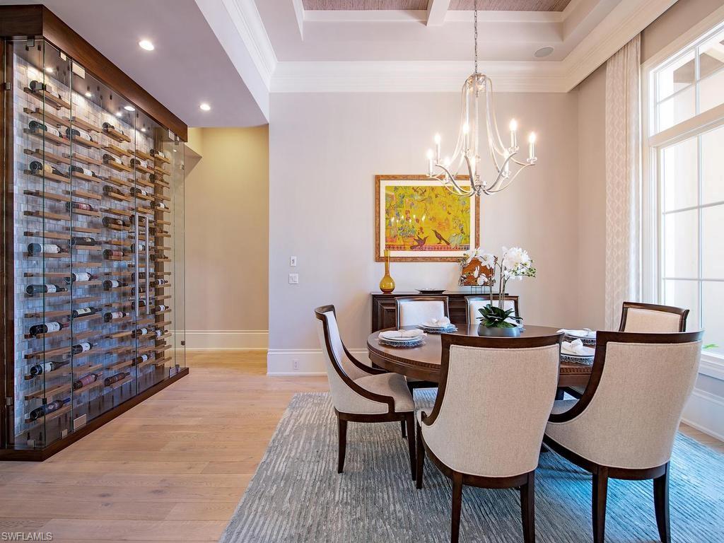 2202 Miramonte Way Naples, FL 34105 - Photo 10 of 23 a view of a dining room with furniture and chandelier