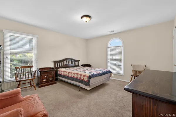 a spacious bedroom with a bed and a couch