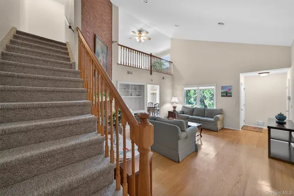 a living room with furniture wooden floor and a chandelier