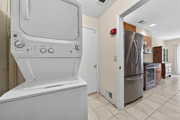 a view of washer and dryer with kitchen in the background