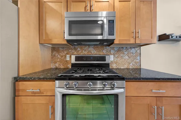 a stove top oven sitting inside of a kitchen
