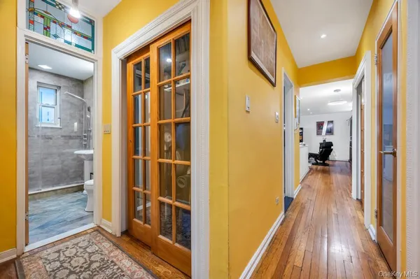 a view of a hallway with wooden floor and staircase
