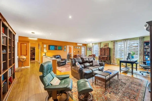 a living room with furniture and a floor to ceiling window