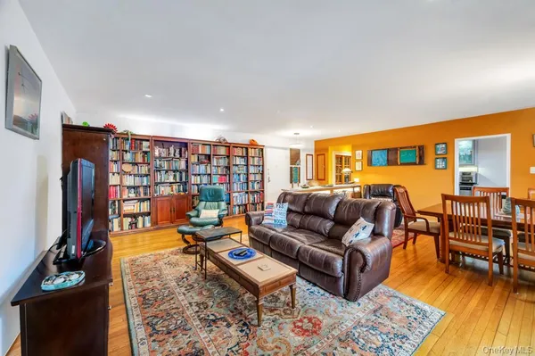 a living room with furniture a rug and a flat screen tv