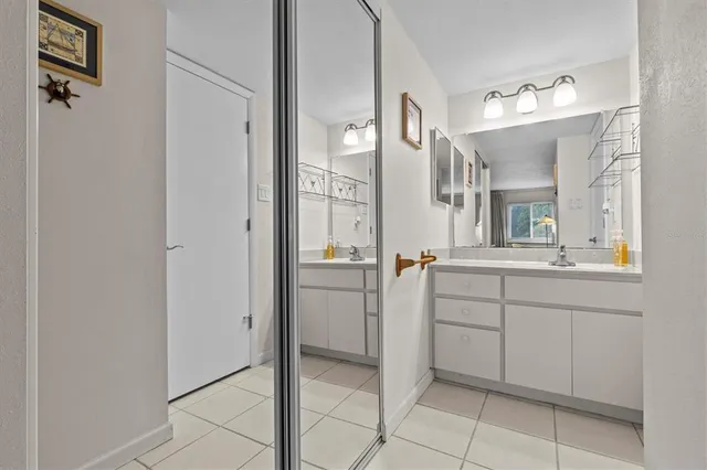 a bathroom with a sink vanity and mirror