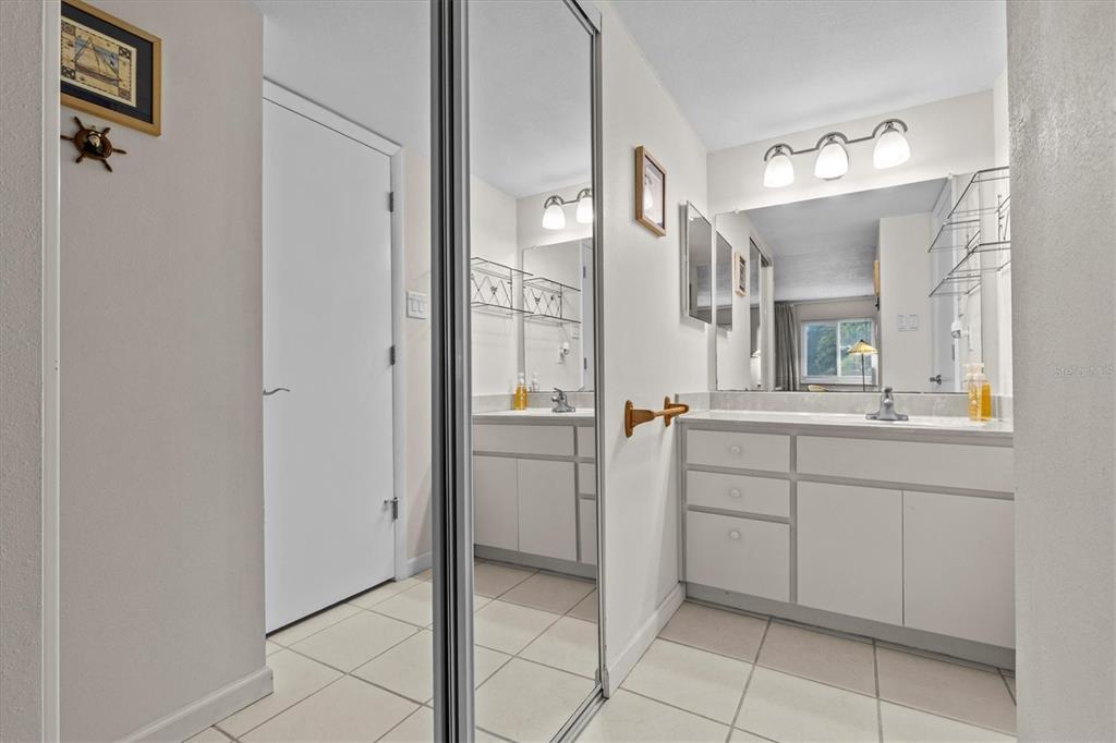 1800 Mariner Drive, Unit 9 Tarpon Springs, FL 34689 - Photo 21 of 41 a bathroom with a sink vanity and mirror