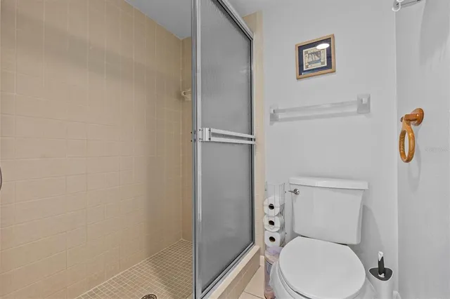 a white toilet sitting next to a bathroom sink