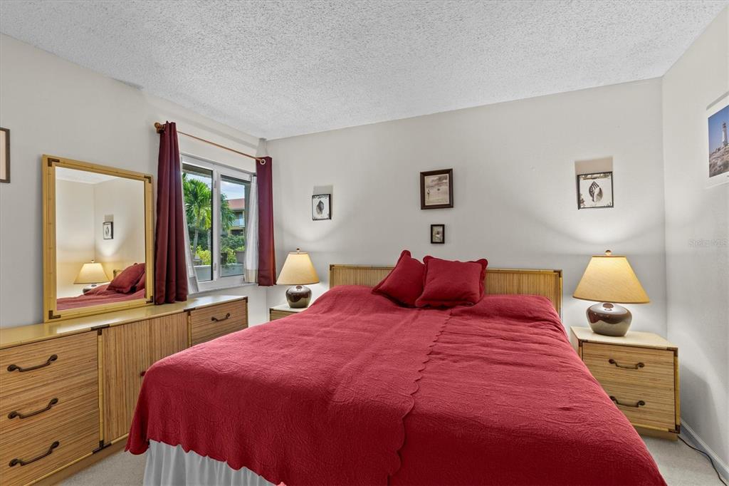 1800 Mariner Drive, Unit 9 Tarpon Springs, FL 34689 - Photo 25 of 41 a bedroom with a large bed and a dresser