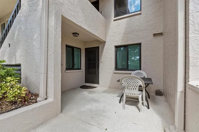 a balcony with table and chairs