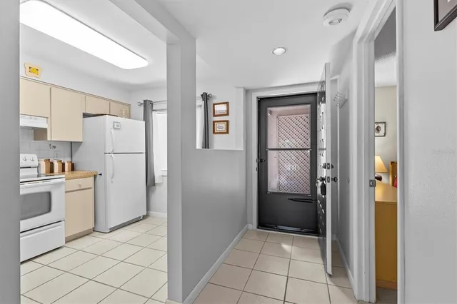a kitchen with a refrigerator and cabinets