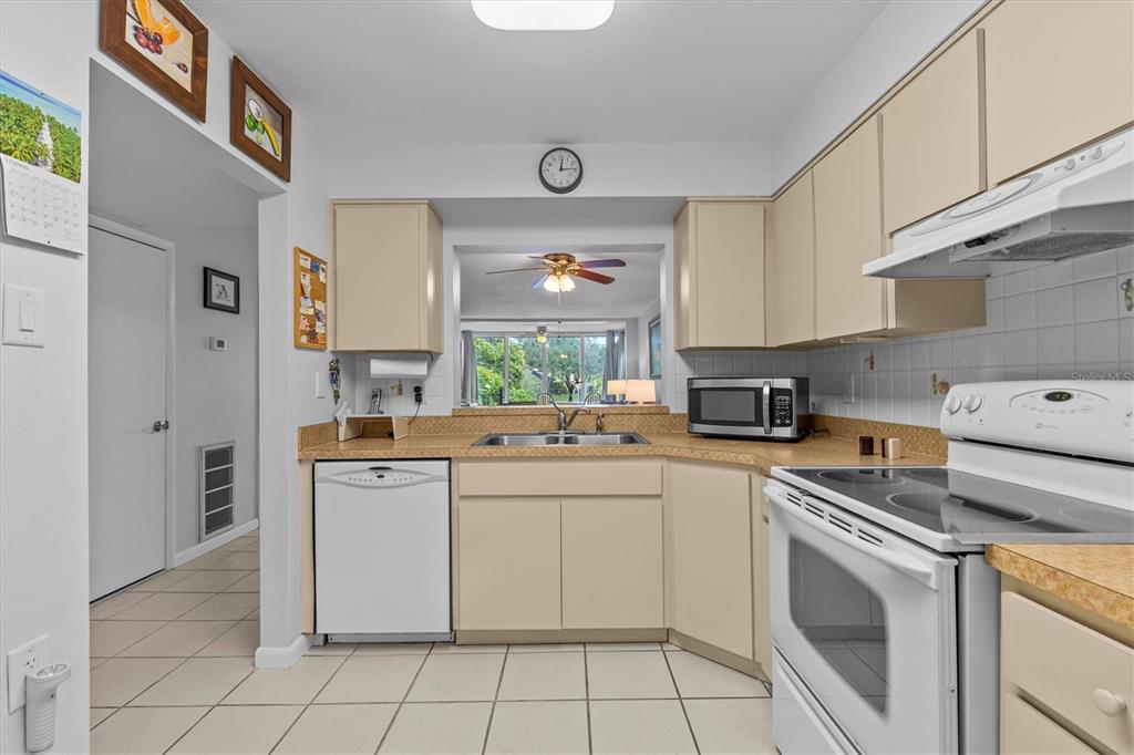 1800 Mariner Drive, Unit 9 Tarpon Springs, FL 34689 - Photo 10 of 41 a kitchen with cabinets appliances a sink and a counter top