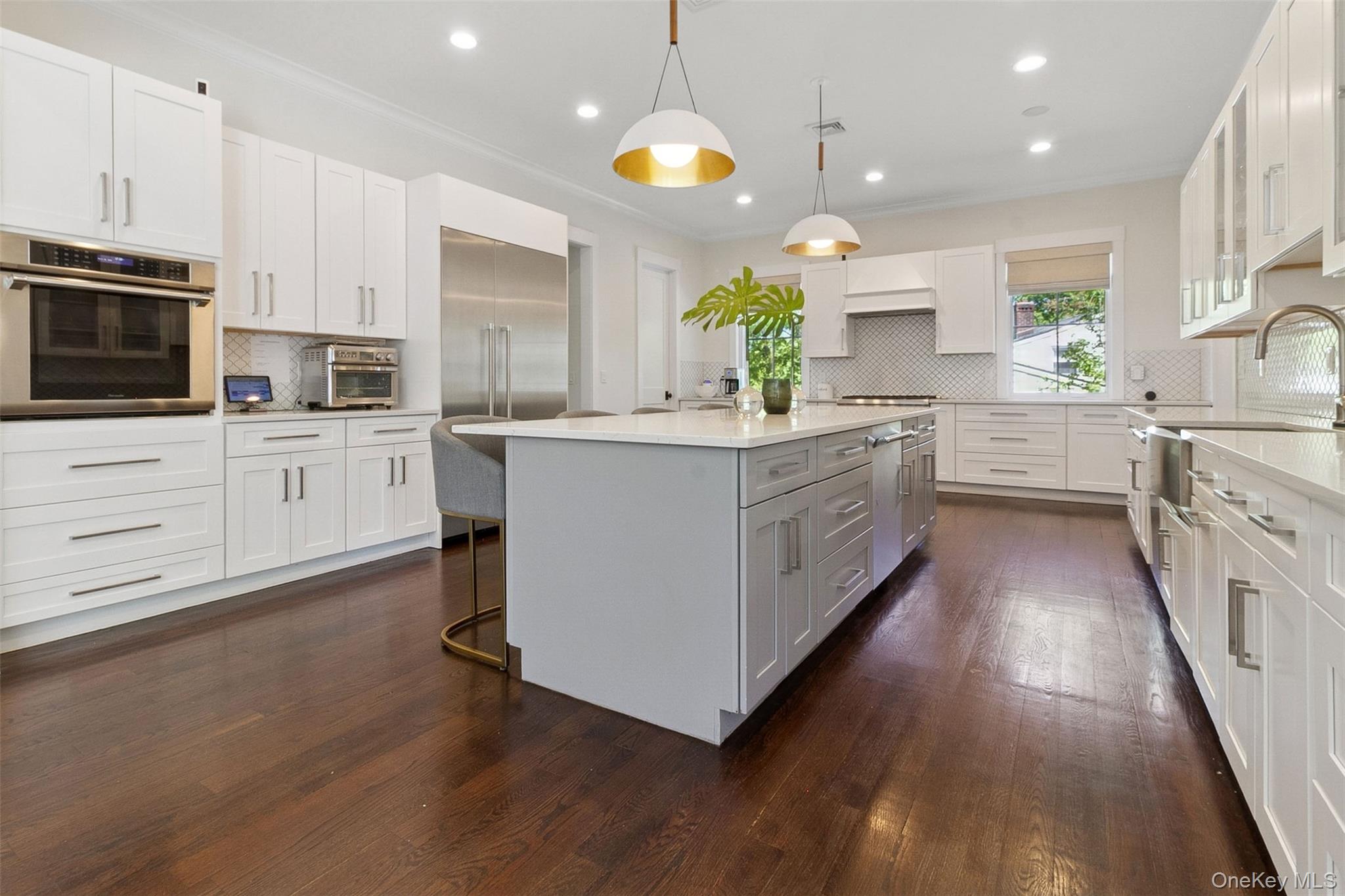 1 Stonewall Lane Mamaroneck, NY 10543 - Photo 13 of 33 a kitchen with stainless steel appliances kitchen island granite countertop a stove a sink and a refrigerator