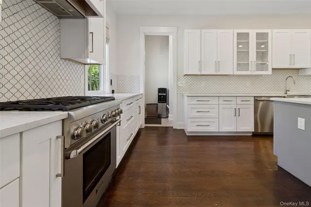 a kitchen with stainless steel appliances a stove sink and cabinets