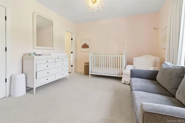 a view of a bedroom with furniture and window