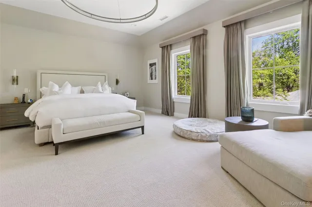 a spacious bedroom with two beds and large window