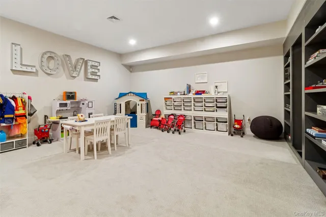 a view of a play room with furniture and toys