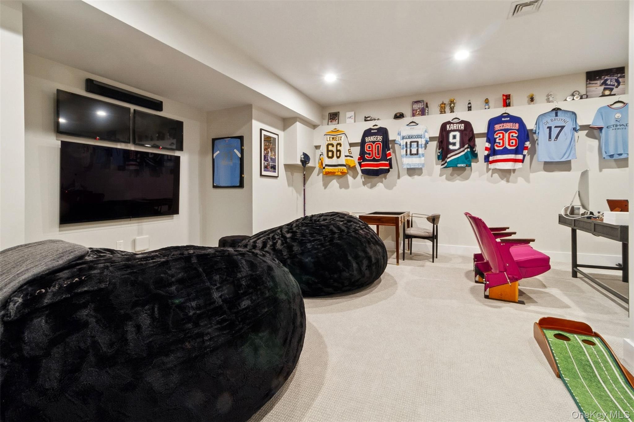 1 Stonewall Lane Mamaroneck, NY 10543 - Photo 24 of 33 a living room with furniture and a flat screen tv