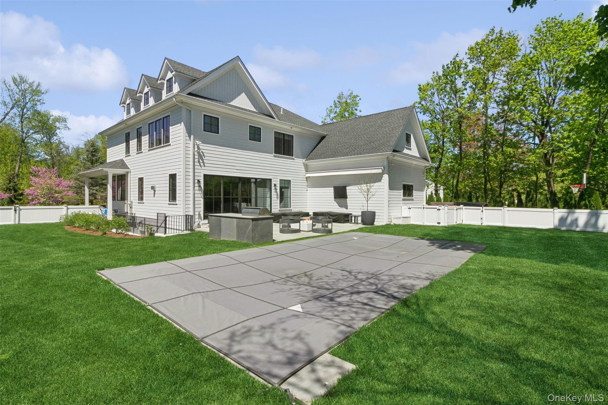 1 Stonewall Lane Mamaroneck, NY 10543 - Photo 27 of 33 a view of a white house with a yard and plants