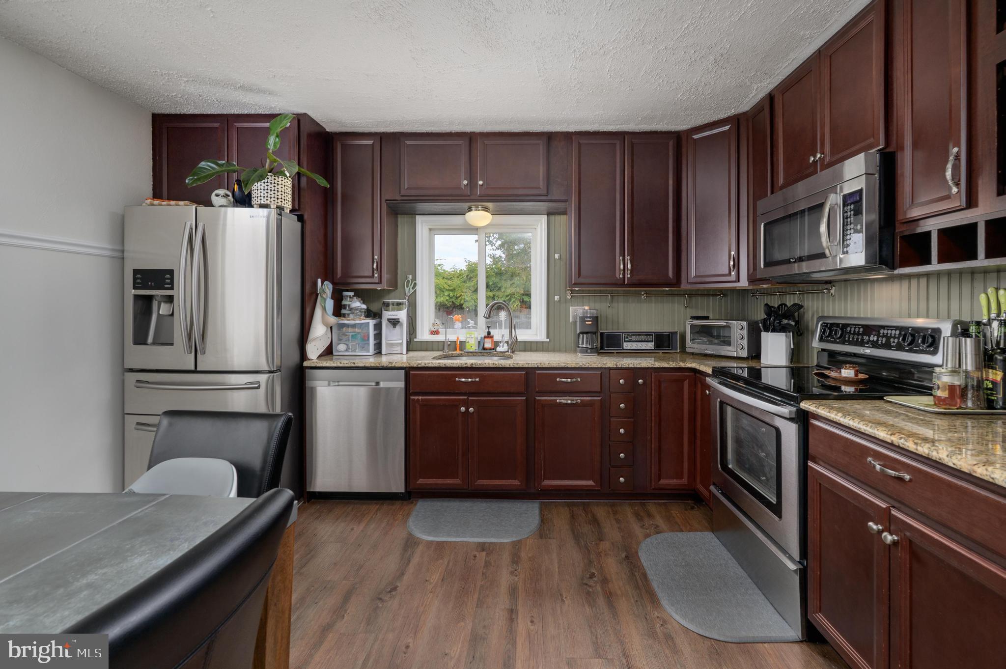 145 New Road Tabernacle, NJ 08088 - Photo 6 of 25 a kitchen with a sink wooden floor and stainless steel appliances