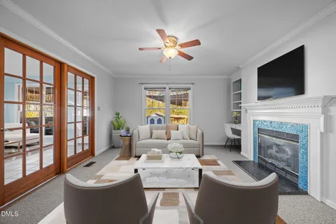 a living room with furniture a fireplace and a flat screen tv