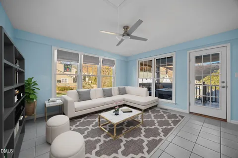 a spacious bedroom with a bed a chandelier and a potted plant