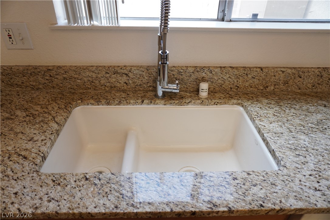 8328 Del Rey Avenue Las Vegas, NV 89117 - Photo 16 of 38 Premium granite counters and a dual basin sink provide functionality in this culinary space.