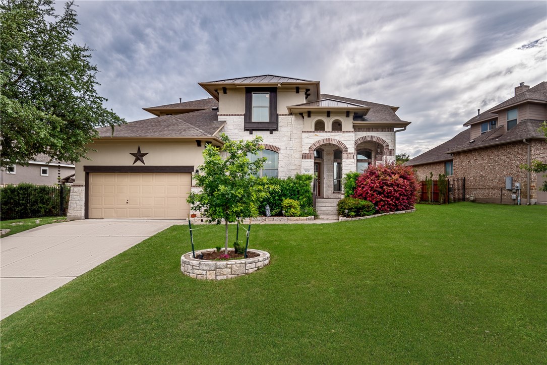 5528 Wild Foxglove Road Spicewood, TX 78669 - Photo 1 of 1 a front view of a house with a garden
