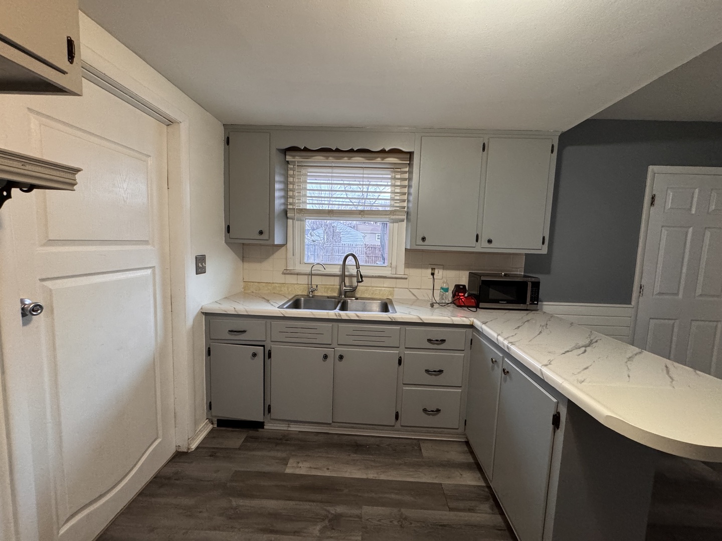 403 Michigan Avenue Aurora, IL 60506 - Photo 4 of 12 a kitchen with a sink cabinets appliances and a window
