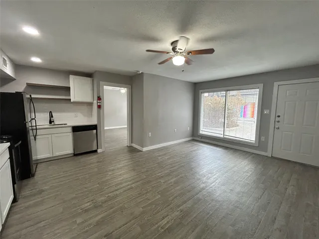 a view of a kitchen with a sink and a stove top oven
