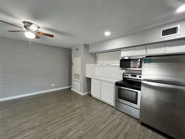 a kitchen with stainless steel appliances granite countertop a stove and a refrigerator